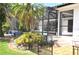 A beautifully landscaped backyard with a pool, lush greenery, and garden at 3724 Bordeaux Dr, Punta Gorda, FL 33950