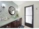 Bathroom with tiled wall, glass sink, and dark wood cabinets at 3724 Bordeaux Dr, Punta Gorda, FL 33950