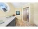 Bathroom featuring sleek quartz countertop, stylish cabinetry, and an enclosed shower at 3724 Bordeaux Dr, Punta Gorda, FL 33950