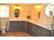 Bathroom with dual sinks, quartz countertop, shaker cabinets, and unique decorative mirrors at 3724 Bordeaux Dr, Punta Gorda, FL 33950
