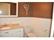 Bathroom with neutral color scheme, wainscoting, and modern toilet and sink at 3724 Bordeaux Dr, Punta Gorda, FL 33950