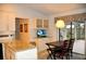 Breakfast nook with pendant light, glass cabinets, and view of the backyard at 3724 Bordeaux Dr, Punta Gorda, FL 33950