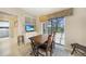 Cozy dining area with a table and chairs, complete with a TV, built-in cabinets and a view of the screened-in lanai at 3724 Bordeaux Dr, Punta Gorda, FL 33950