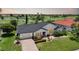 Charming home with lush lawn, a brick driveway and colorful landscaping at 3724 Bordeaux Dr, Punta Gorda, FL 33950