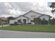 Bright single-story home featuring a well-manicured lawn, mature landscaping, and brick driveway at 3724 Bordeaux Dr, Punta Gorda, FL 33950