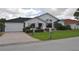 Charming single-story home with a brick driveway, well-manicured lawn and mature landscaping at 3724 Bordeaux Dr, Punta Gorda, FL 33950
