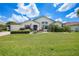 Well-maintained home with a lush green lawn, mature shrubs, and a welcoming front entrance at 3724 Bordeaux Dr, Punta Gorda, FL 33950