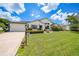 Charming home featuring a neatly landscaped front yard, a well-lit walkway, and an attached garage at 3724 Bordeaux Dr, Punta Gorda, FL 33950