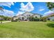 Inviting two-story home with a well-manicured lawn and vibrant landscaping at 3724 Bordeaux Dr, Punta Gorda, FL 33950