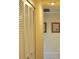 Neutral hallway featuring closet with shuttered doors and framed heron artwork on the wall at 3724 Bordeaux Dr, Punta Gorda, FL 33950