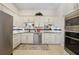 Well-equipped kitchen with stainless steel appliances, white cabinets, granite countertops, and decorative backsplash at 3724 Bordeaux Dr, Punta Gorda, FL 33950