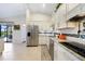Bright kitchen featuring stainless steel appliances, a granite counter, and open access to dining and outdoor spaces at 3724 Bordeaux Dr, Punta Gorda, FL 33950