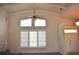 Living room featuring clerestory windows, vaulted ceilings, and access to the foyer at 3724 Bordeaux Dr, Punta Gorda, FL 33950