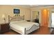 Main bedroom featuring wood floors, a king bed, nightstands, and lots of closet space at 3724 Bordeaux Dr, Punta Gorda, FL 33950
