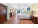Spacious main bedroom with wood floors, walk-out access to lanai, and an ensuite bathroom at 3724 Bordeaux Dr, Punta Gorda, FL 33950