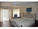 Comfortable main bedroom with a king-sized bed, ceiling fan, and sliding door for natural light at 3724 Bordeaux Dr, Punta Gorda, FL 33950