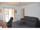 Comfortable home office featuring a gray sofa, desk and floral curtains at 3724 Bordeaux Dr, Punta Gorda, FL 33950