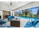 Screened patio with comfortable seating around a modern fire pit overlooking the pool and lush landscaping at 3724 Bordeaux Dr, Punta Gorda, FL 33950