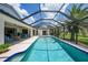 This covered pool features a cool blue plaster and plenty of lounging space at 3724 Bordeaux Dr, Punta Gorda, FL 33950