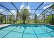 Inviting screened-in pool area surrounded by mature palm trees and manicured landscaping under a sunny sky at 3724 Bordeaux Dr, Punta Gorda, FL 33950