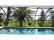 Inviting screened-in pool area with a view of the lush green golf course at 3724 Bordeaux Dr, Punta Gorda, FL 33950