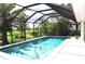Relaxing screened-in pool with palm trees and tropical landscaping at 3724 Bordeaux Dr, Punta Gorda, FL 33950