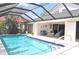 Inviting screened-in pool area with comfortable outdoor seating and lounging at 3724 Bordeaux Dr, Punta Gorda, FL 33950