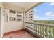 A balcony with white railings showcasing a view of the city and building at 3730 Cadbury Cir # 616, Venice, FL 34293