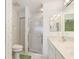 Bathroom featuring a glass door walk-in shower, vanity and toilet with floral wallpaper at 3730 Cadbury Cir # 616, Venice, FL 34293