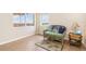 Bright bedroom featuring natural light, wood floors, and a wicker sofa at 3730 Cadbury Cir # 616, Venice, FL 34293