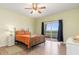 Bright bedroom with neutral walls, wooden floors, and a slider to the outdoor balcony at 3730 Cadbury Cir # 616, Venice, FL 34293