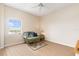 Well-lit bedroom features wood floors, ceiling fan, and a comfortable wicker sofa at 3730 Cadbury Cir # 616, Venice, FL 34293
