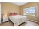 Charming bedroom with floral bedding, a side table and a sunlit window at 3730 Cadbury Cir # 616, Venice, FL 34293