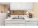 Clean kitchen with white cabinets, stainless steel sink and view of the balcony at 3730 Cadbury Cir # 616, Venice, FL 34293