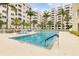Inviting community pool with clear blue water, surrounded by palm trees and lounge seating at 3730 Cadbury Cir # 616, Venice, FL 34293