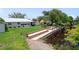 A serene backyard view showcases a well-maintained lawn and canal-side dock area at 405 Ridgecrest Dr, Punta Gorda, FL 33982
