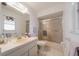 A well-lit bathroom features a shower-tub combo, a mirror, and modern fixtures at 405 Ridgecrest Dr, Punta Gorda, FL 33982