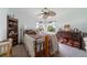 A quaint bedroom featuring charming decor, a ceiling fan, and plenty of natural light at 405 Ridgecrest Dr, Punta Gorda, FL 33982