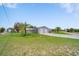 Wide shot showcasing a two-car garage, driveway, and grassy yard, providing ample parking and outdoor space at 405 Ridgecrest Dr, Punta Gorda, FL 33982