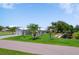 An exterior view of the home featuring a long driveway and access to a canal at 405 Ridgecrest Dr, Punta Gorda, FL 33982