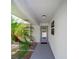 Close-up of a charming home entrance featuring a decorative glass front door and lush landscaping at 405 Ridgecrest Dr, Punta Gorda, FL 33982
