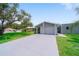 Charming single-story home with a well-maintained lawn, spacious driveway, and attached one-car garage at 405 Ridgecrest Dr, Punta Gorda, FL 33982