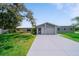 Charming single-story home with a well-manicured lawn and a long driveway leading to an attached garage at 405 Ridgecrest Dr, Punta Gorda, FL 33982