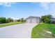 Spacious two-car garage with a long concrete driveway, set in a serene grassy yard at 405 Ridgecrest Dr, Punta Gorda, FL 33982