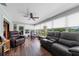 Bright sunroom with wood floors, ceiling fan, and comfortable seating, bathed in natural light at 405 Ridgecrest Dr, Punta Gorda, FL 33982