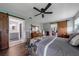 A spacious primary bedroom features a ceiling fan, wood floors, and barn doors at 405 Ridgecrest Dr, Punta Gorda, FL 33982