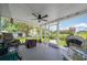 Covered screened-in patio features comfortable seating, a grill, and views of the backyard at 405 Ridgecrest Dr, Punta Gorda, FL 33982