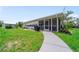 Wide screened porch on a well-maintained, green lawn at 405 Ridgecrest Dr, Punta Gorda, FL 33982
