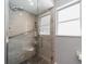Tiled walk-in shower with glass door, grab bar, rainfall shower head, and built in shelves at 405 Ridgecrest Dr, Punta Gorda, FL 33982