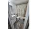 Cozy bathroom featuring a shower with a decorative curtain and grey accent rugs at 4158 Tamiami Trl # U4, Port Charlotte, FL 33952